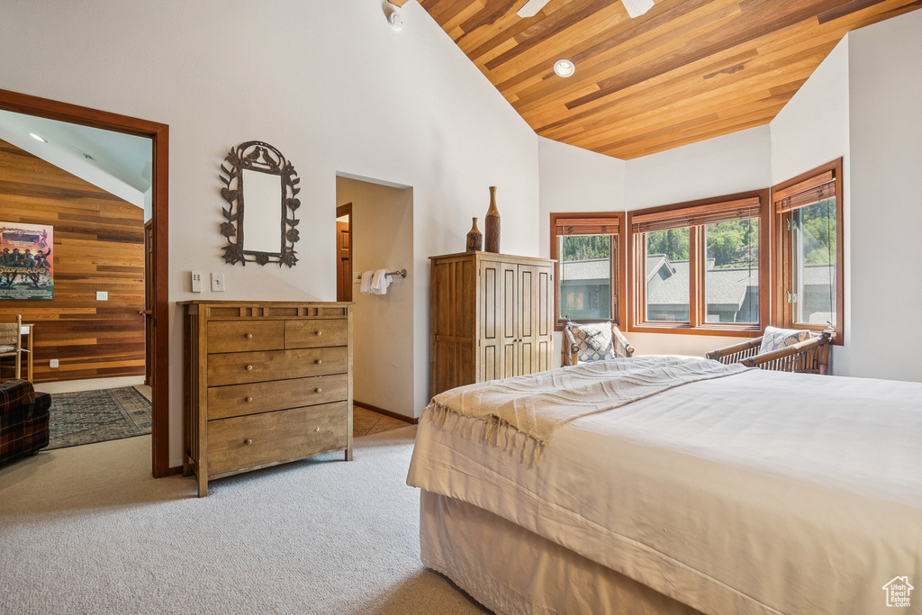 Bedroom featuring carpet, wood ceiling, and high vaulted ceiling