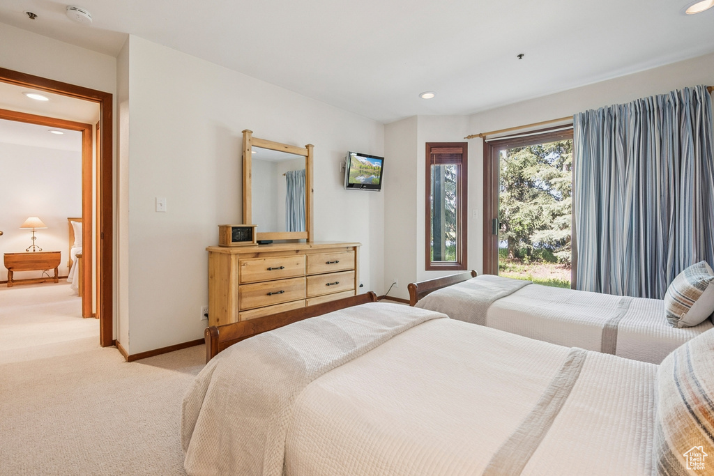 Bedroom with recessed lighting, light colored carpet, and baseboards
