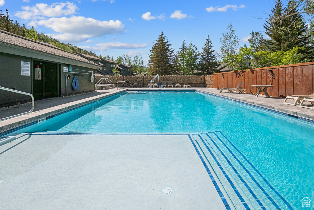 Community pool featuring a patio