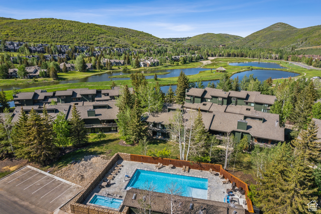 Aerial view of residential area with a water and mountain view and a pool area