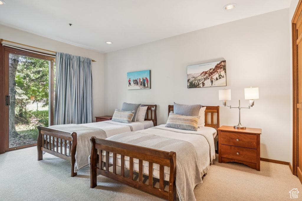 Bedroom featuring light colored carpet, access to exterior, recessed lighting, and baseboards