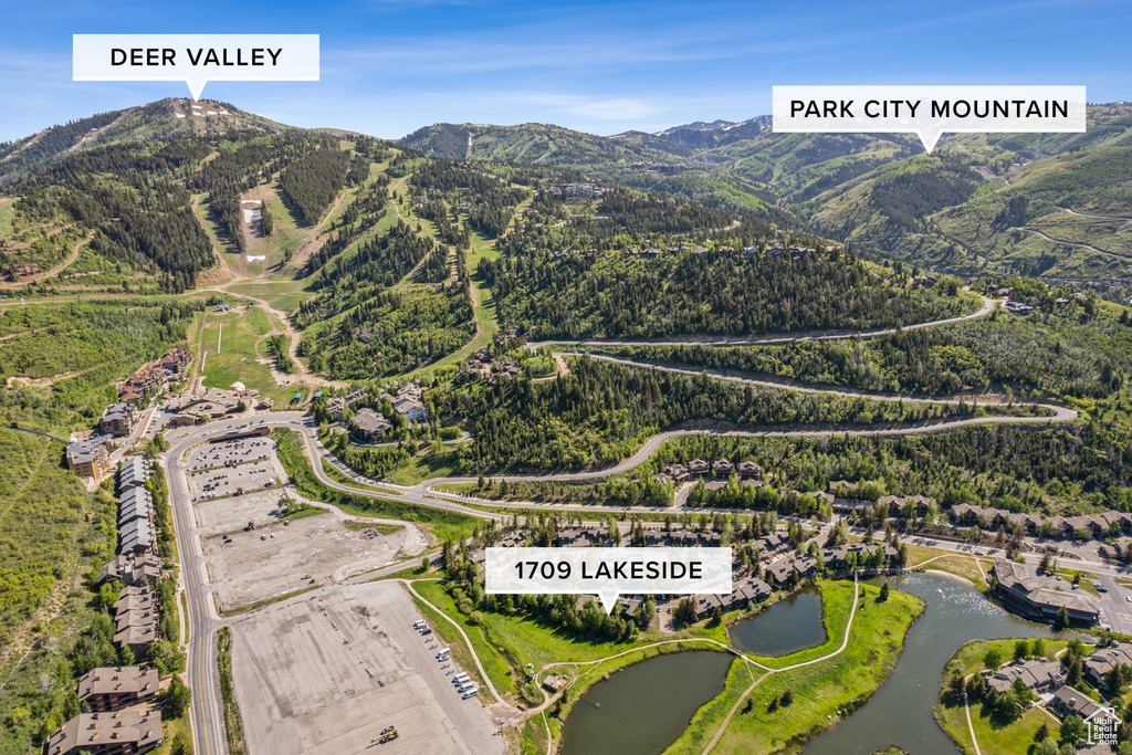 Aerial overview of property's location featuring a water and mountain view