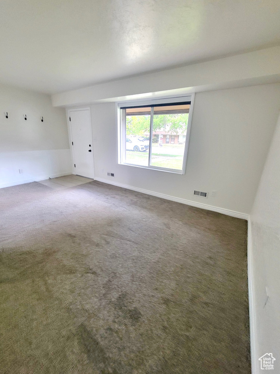 Unfurnished room with carpet floors and baseboards