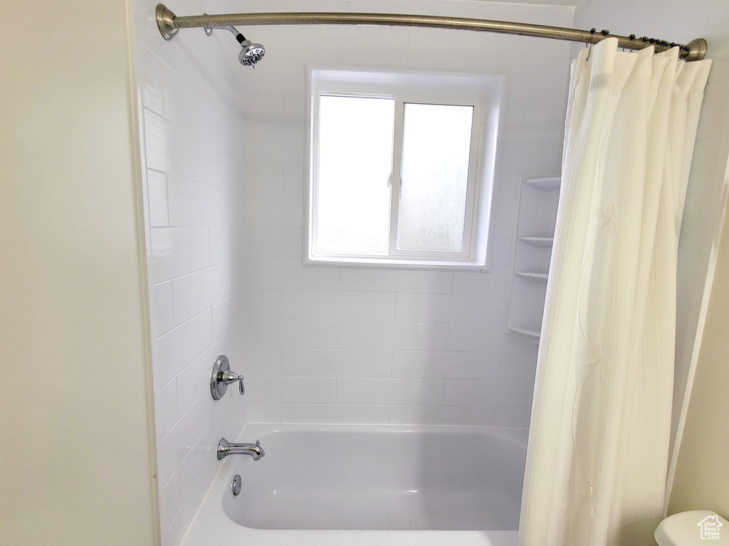 Full bathroom featuring shower / bath combo and toilet