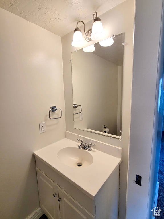 Bathroom featuring vanity and a textured ceiling