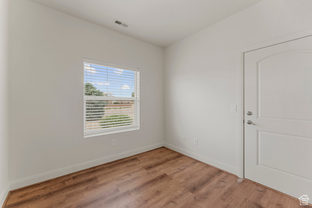 Unfurnished room featuring light wood-style flooring and baseboards