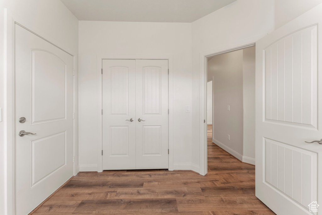 Hallway with wood finished floors and baseboards