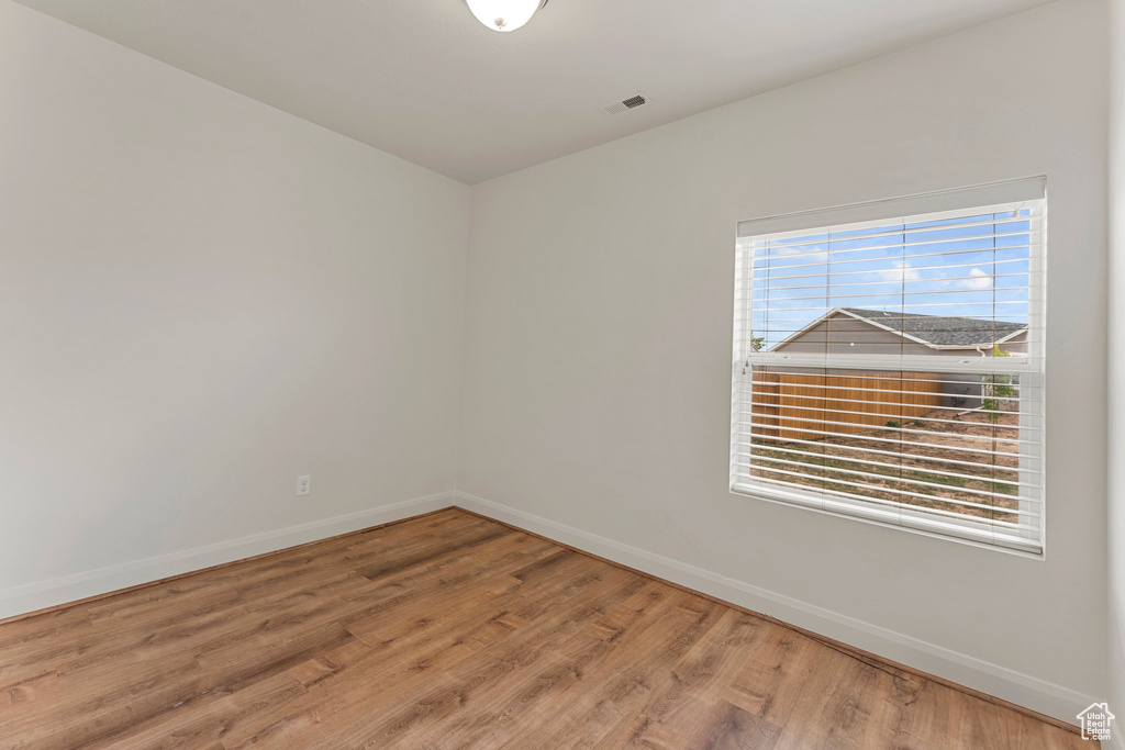 Unfurnished room with baseboards and wood finished floors