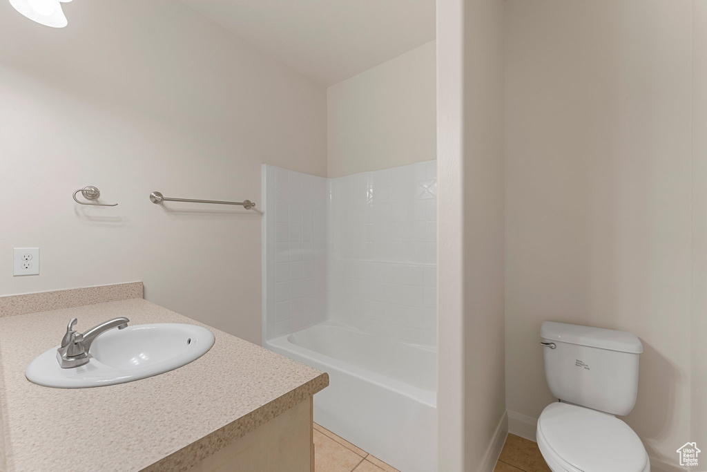 Bathroom with vanity, tile patterned floors, toilet, and bathing tub / shower combination