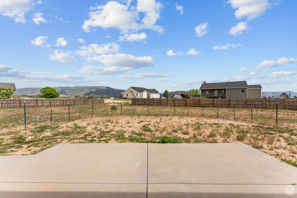 View of yard featuring a patio area, a mountain view, and a view of countryside