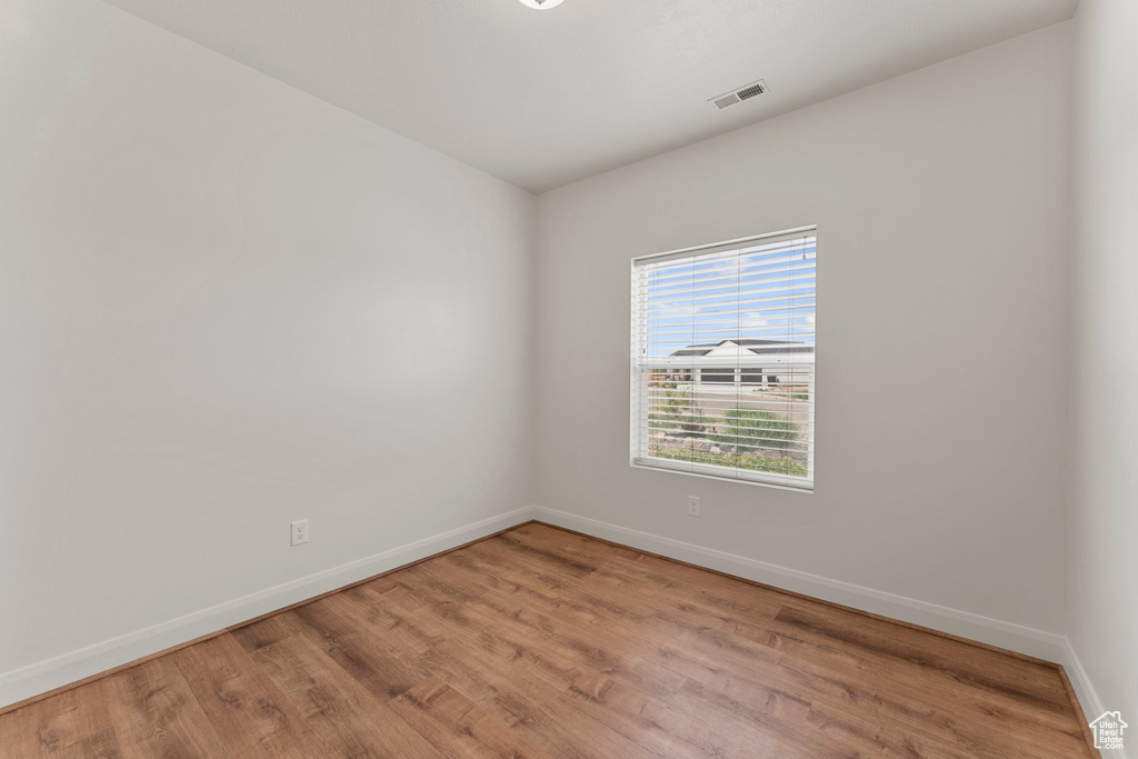 Empty room featuring light wood-style flooring and baseboards