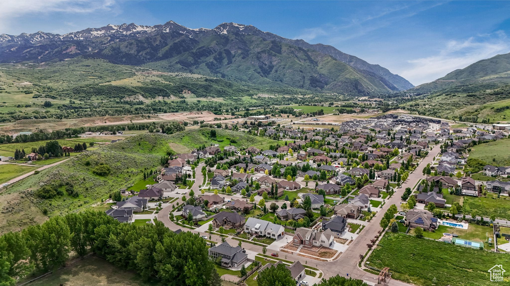 Aerial overview of property's location featuring mountains and nearby suburban area