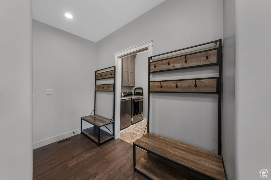 Mudroom featuring independent washer and dryer, dark wood finished floors, baseboards, and recessed lighting