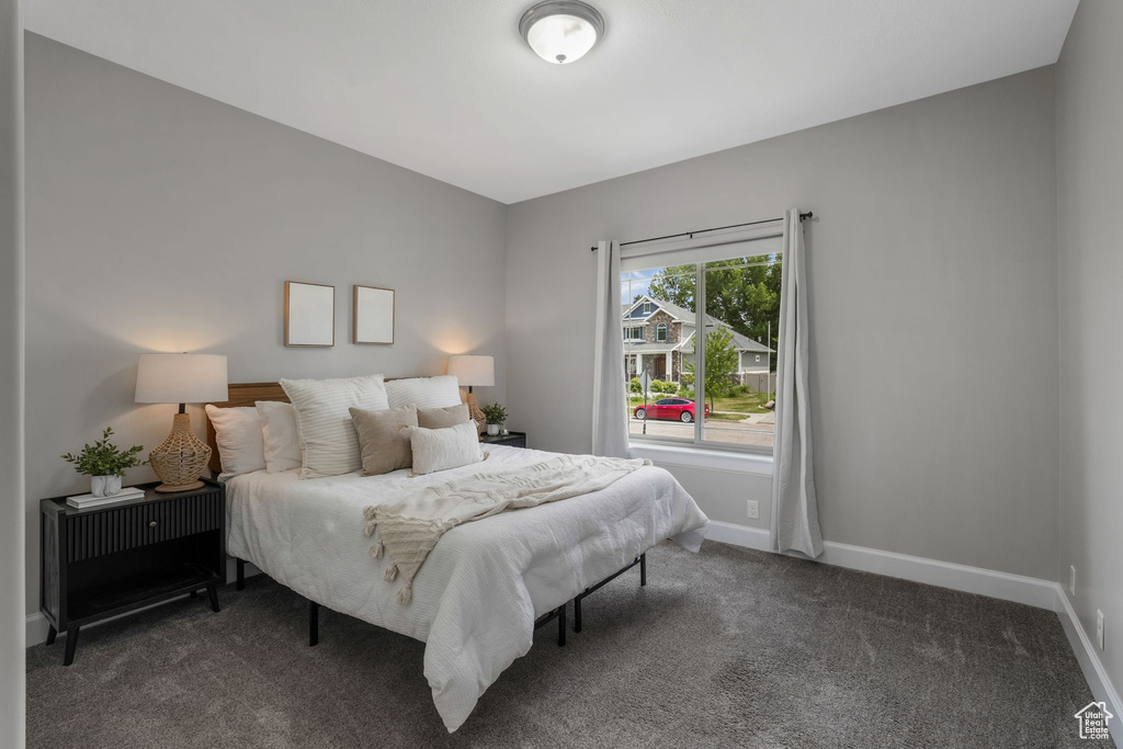 Bedroom featuring baseboards and carpet