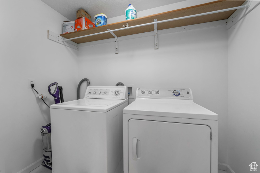 Laundry area with washer and dryer and baseboards