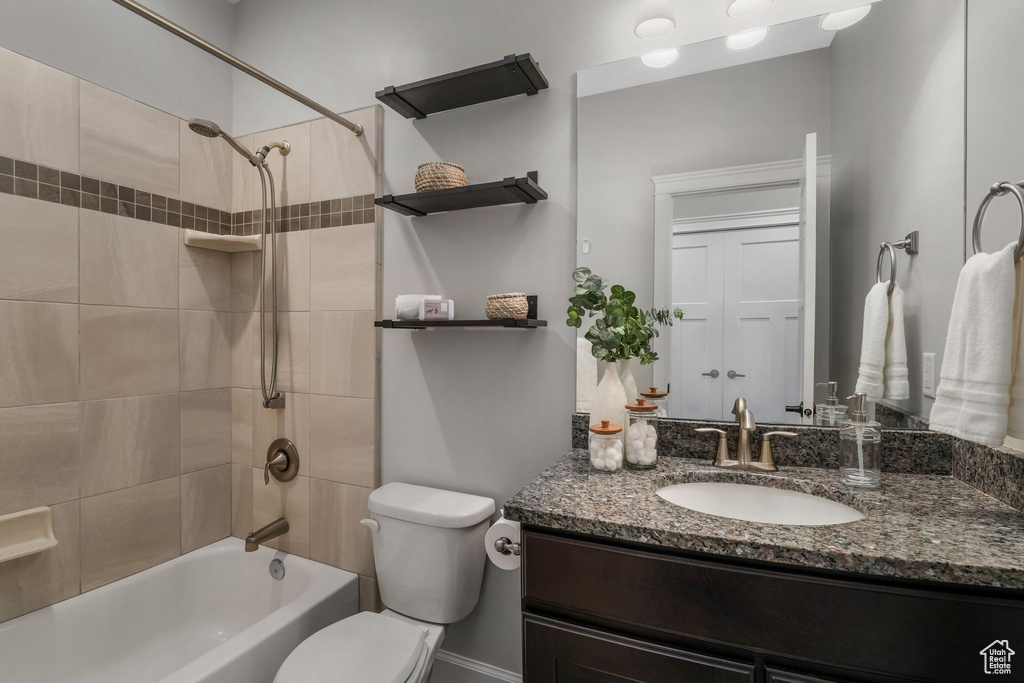 Bathroom with vanity, shower / washtub combination, and toilet