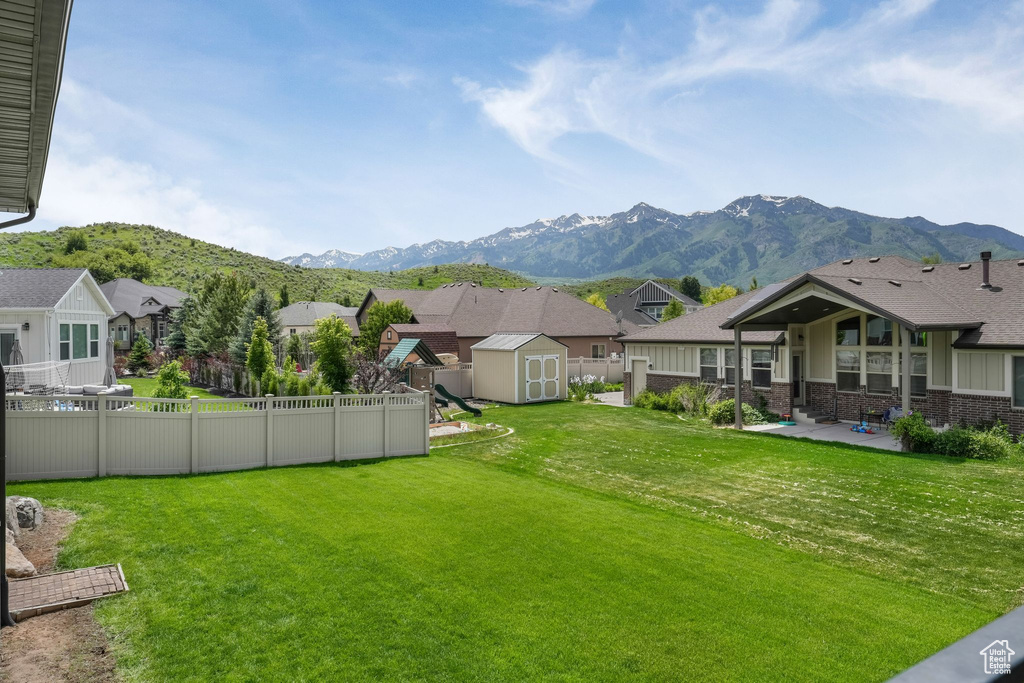 View of yard featuring a patio area, a mountain view, and a residential view