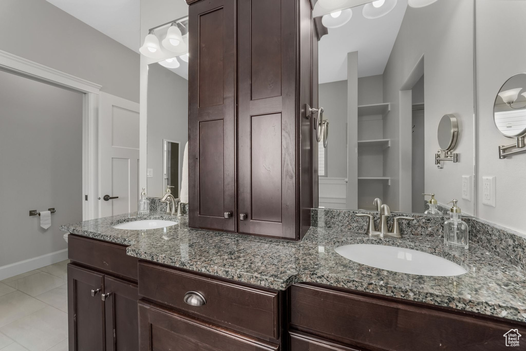 Full bathroom featuring double vanity and tile patterned floors