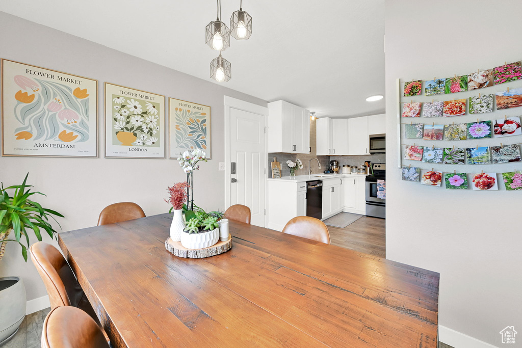 Dining area with baseboards and light wood-type flooring