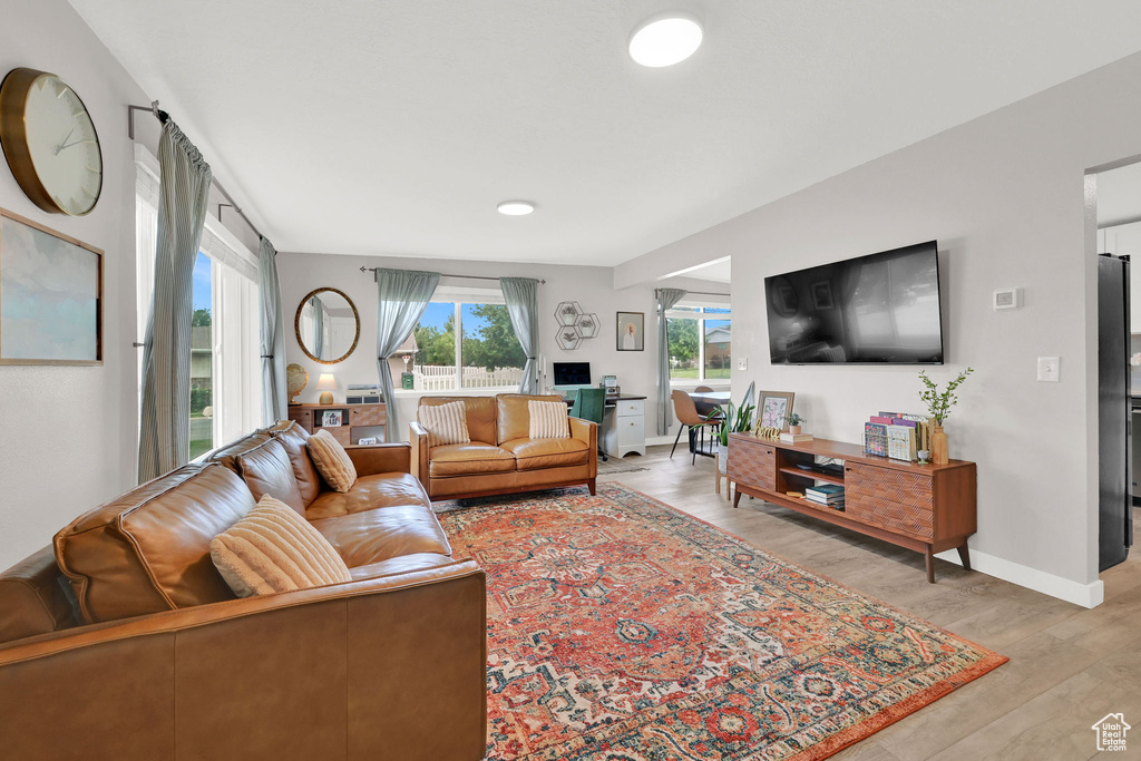 Living room featuring light wood-style flooring and baseboards