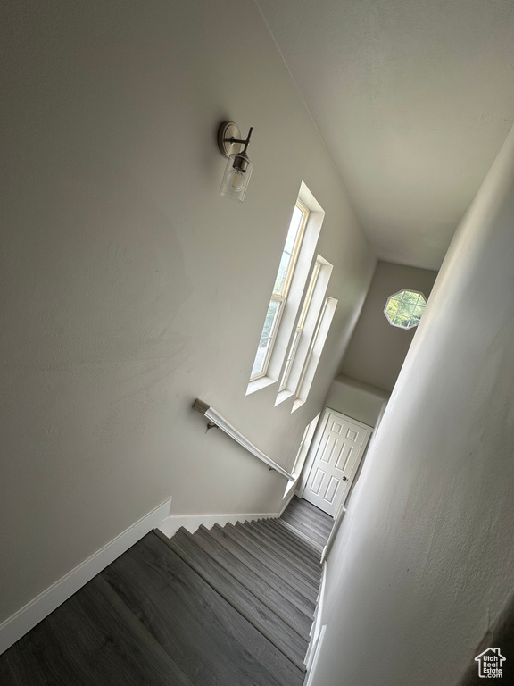 Stairway featuring wood finished floors and baseboards