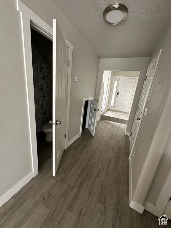 Hall with dark wood finished floors and baseboards