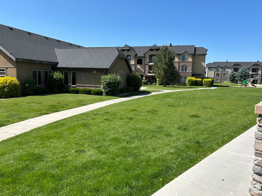 View of front facade with a residential view and a front yard