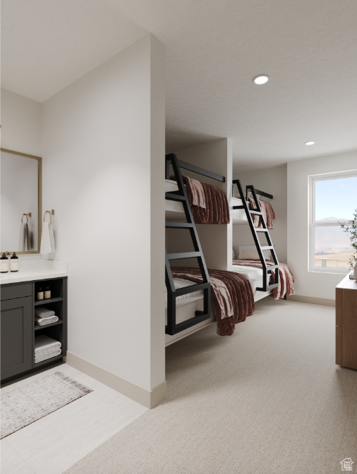 Bedroom with recessed lighting, light colored carpet, and baseboards