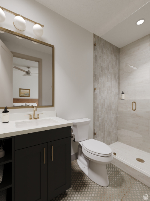 Bathroom featuring a shower stall, vanity, toilet, recessed lighting, and ceiling fan