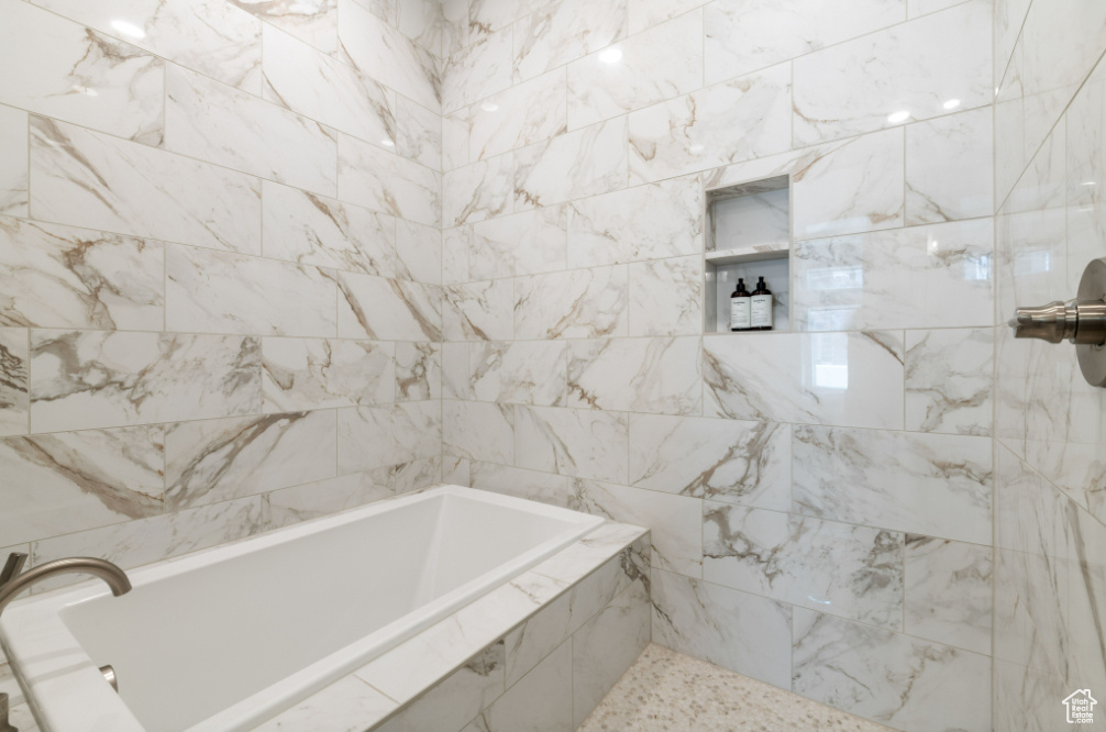 Full bath with tiled bath