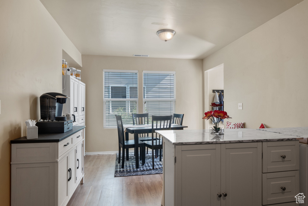 Dining space featuring light wood finished floors and baseboards
