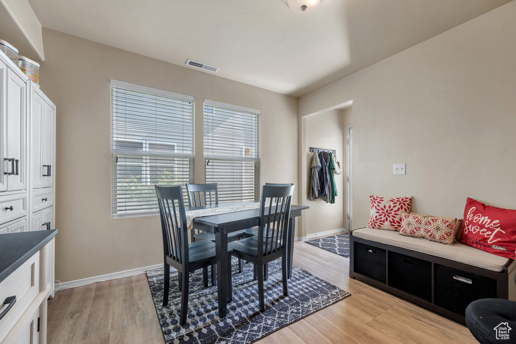Dining area featuring light wood-type flooring and baseboards