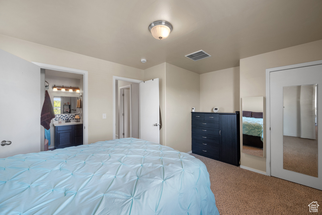 Bedroom with carpet floors and ensuite bath