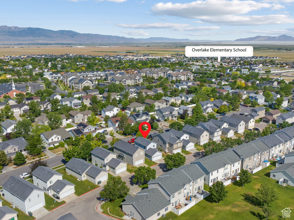 Aerial perspective of suburban area with a mountainous background