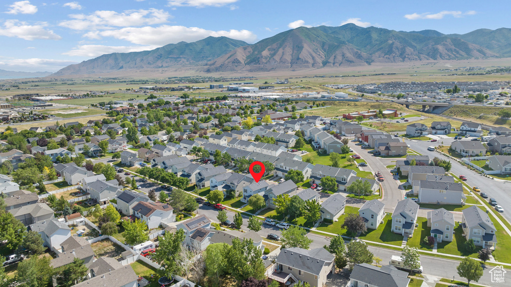 Aerial view of property\'s location with a mountainous background and nearby suburban area
