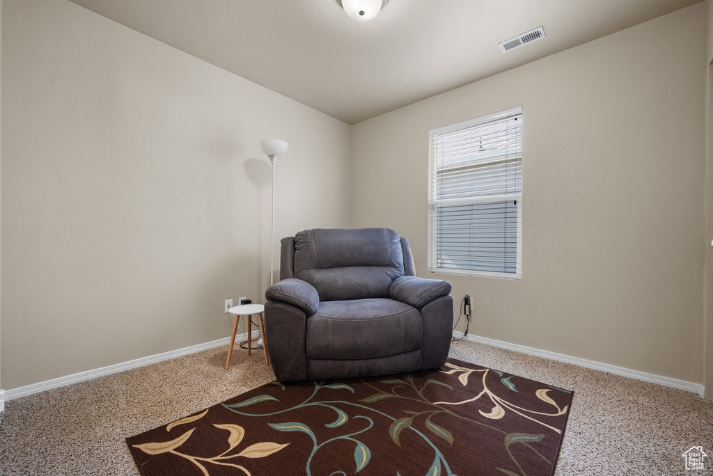 Living area with carpet and baseboards