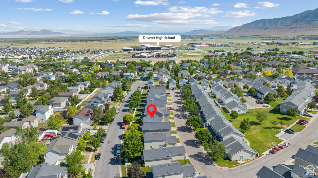 Aerial overview of property\'s location featuring a mountainous background and nearby suburban area