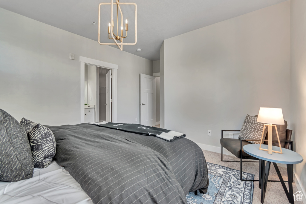 Bedroom with carpet floors, a chandelier, and baseboards