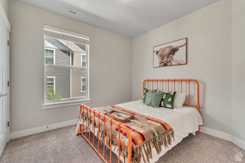 Carpeted bedroom with baseboards