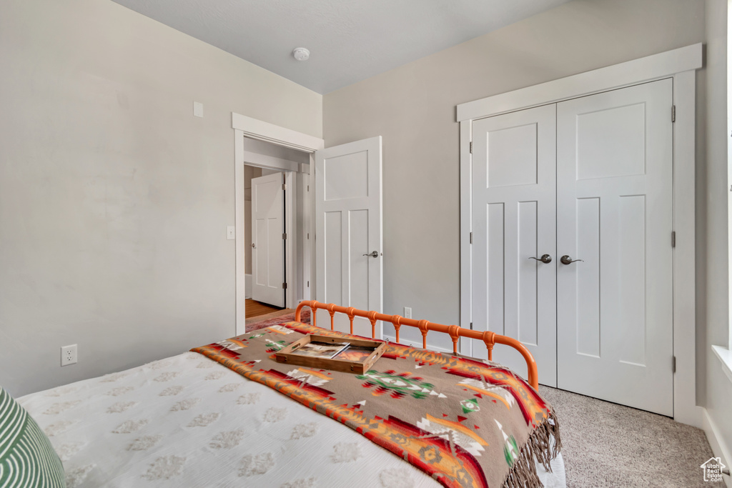 Carpeted bedroom featuring a closet