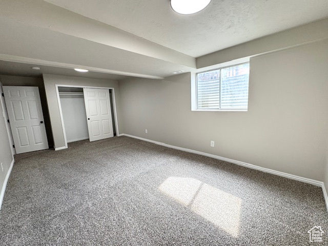 Unfurnished bedroom with baseboards, carpet floors, and a closet