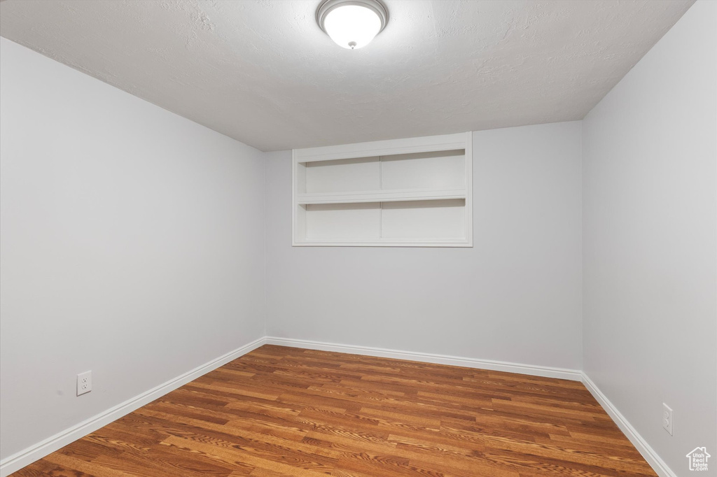 Spare room with wood finished floors and baseboards