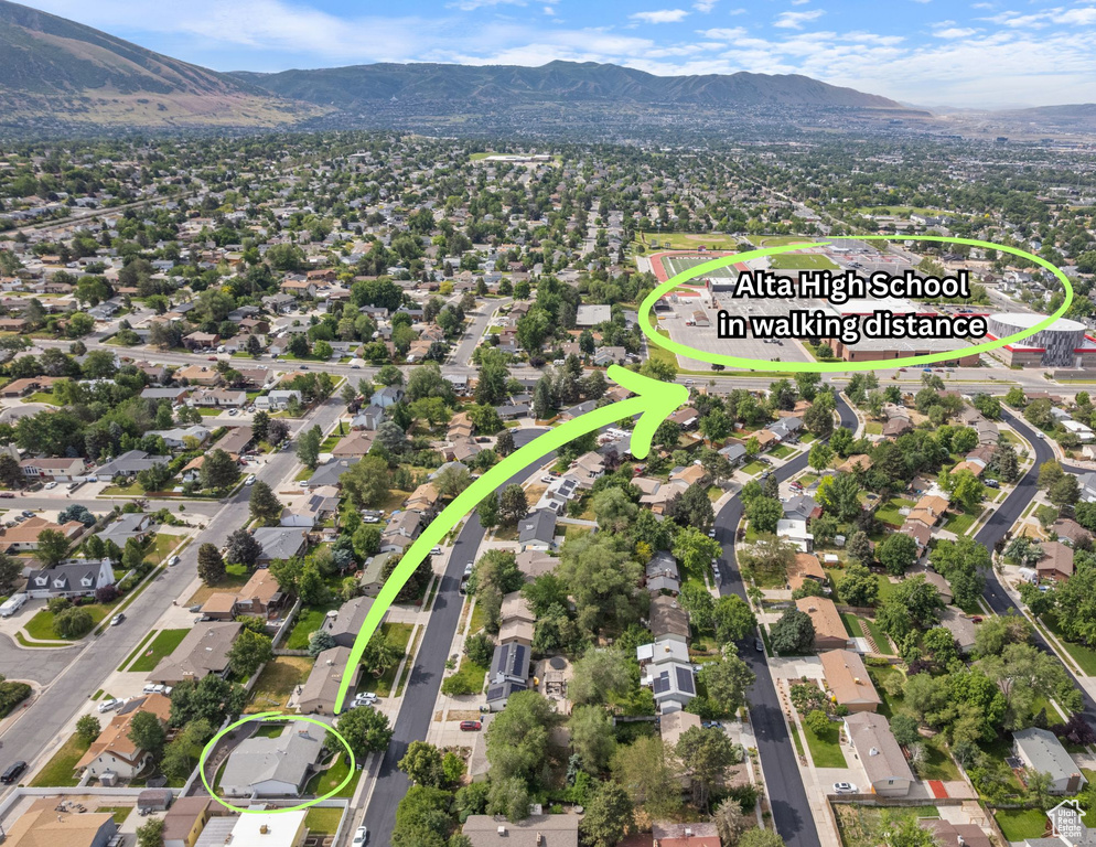 Aerial perspective of suburban area featuring a mountain backdrop
