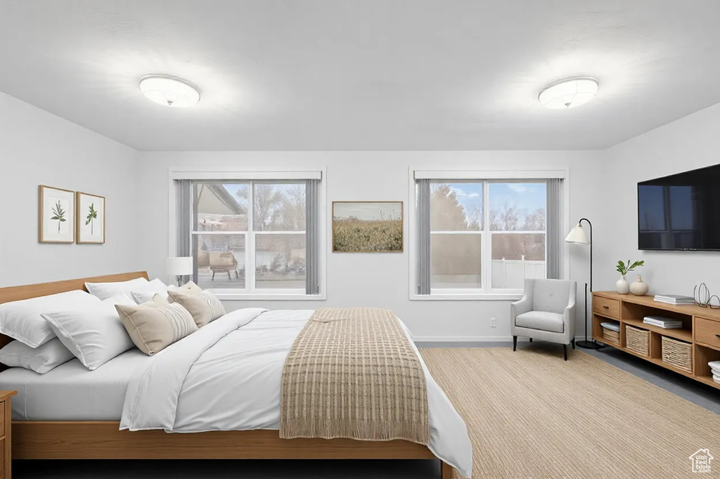 Bedroom featuring multiple windows and baseboards