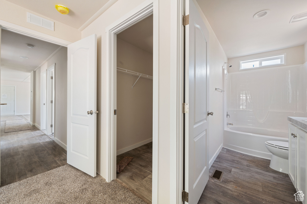 Hall featuring dark wood-type flooring and baseboards