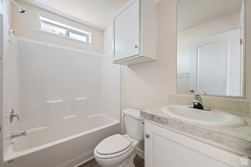 Full bathroom with toilet, vanity, and bathtub / shower combination