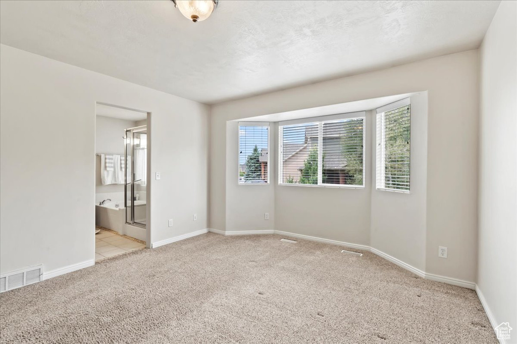 Unfurnished room featuring carpet flooring and baseboards