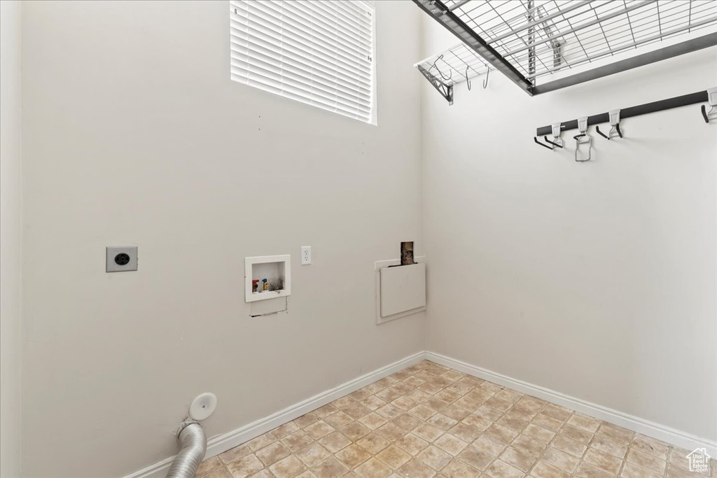 Laundry room featuring electric dryer hookup, hookup for a washing machine, and baseboards