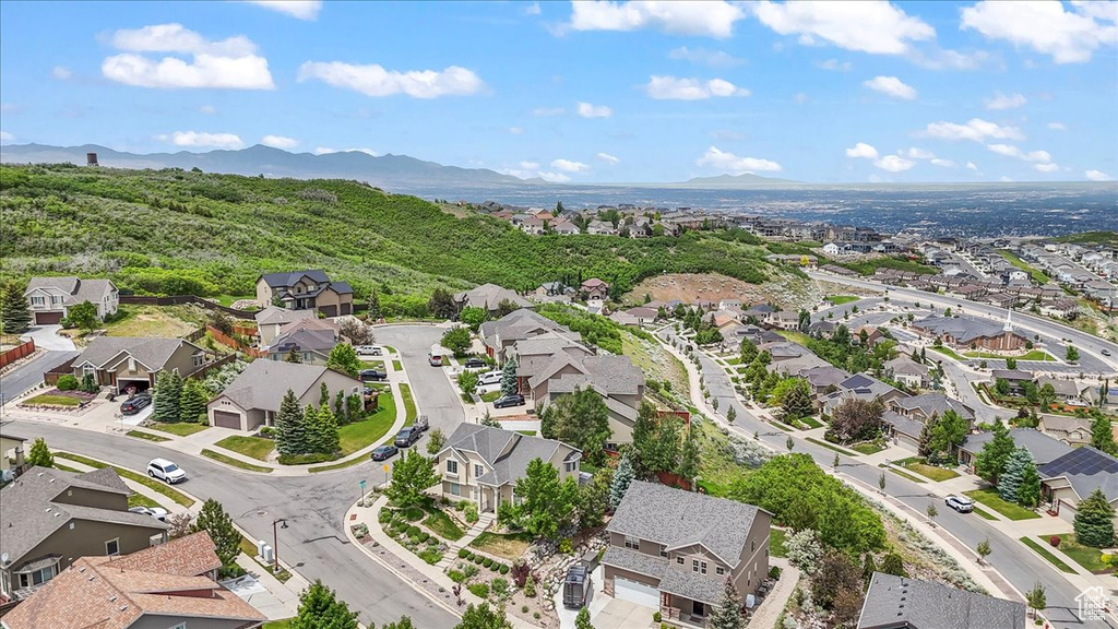 Aerial overview of property's location featuring nearby suburban area and a mountainous background