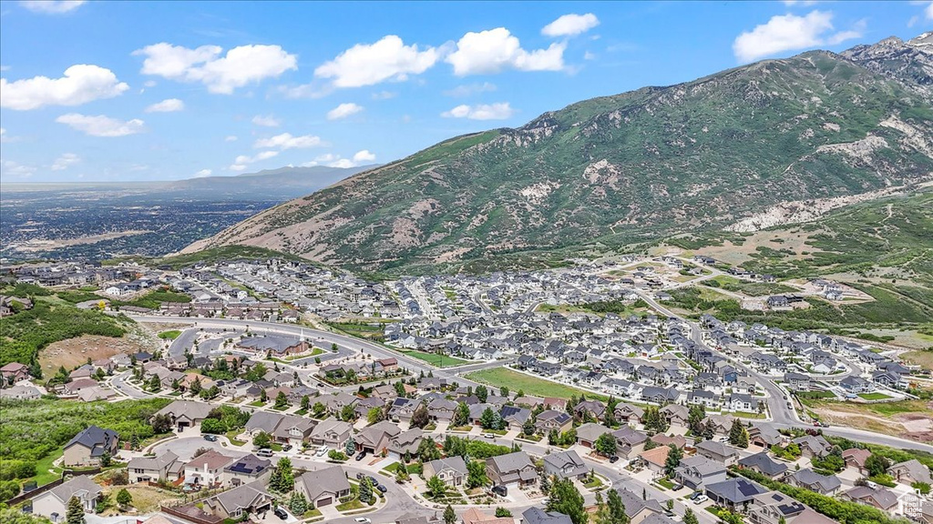 Aerial view of property's location featuring a mountainous background and nearby suburban area